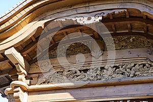 Fragment of wooden facade Karamon gate of central entrance. Japanese garden in public landscape park Krasnodar