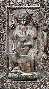 Fragment of wooden nepalese door with Ganesha