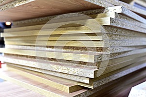 Fragment of a wooden panel made of fiberboard in workshop. Medium Density Fiberboard MDF. Woodworking industry and furniture
