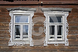 A fragment of the wooden wall of an old house with white platbands in Rostov the Great