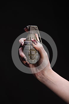 fragmentation grenade in woman hand
