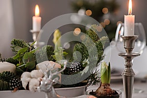 Fragments of Christmas decor, cones, candles on the background of a decorated Christmas tree