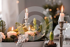 Fragments of Christmas decor, cones, candles on the background of a decorated Christmas tree