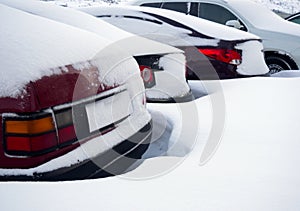 Fragments of parked cars covered with snow