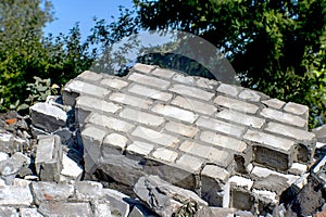 Fragments of a wall of a gray brick at utilization of a brick building