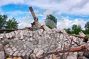 Fragments of white brick ruins, remnants of an old iron structure from a dismantled water tower
