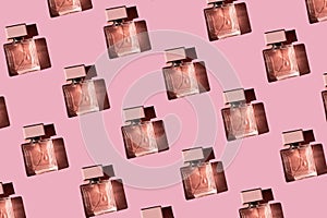 Fragnance parfume pattern. Bottles of pink woman perfume on a pastel pink background, flat lay, top view. Mockup of fragrance
