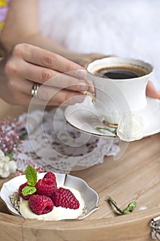 Fragrant coffee in female hands. Breakfast in bed. Romance. light colors