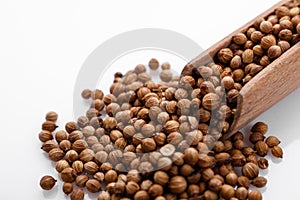 Fragrant coriander seeds on a white background