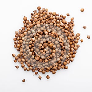 Fragrant coriander seeds on a white background