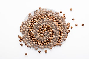 Fragrant coriander seeds on a white background