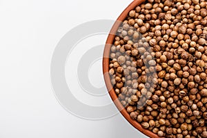 Fragrant coriander seeds on a white background