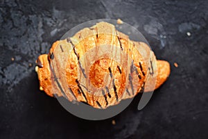 Fragrant croissants on a dark table isolated background. Delicious sweet pastries for breakfast