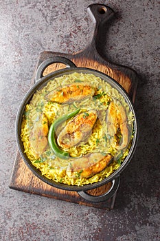 Fragrant and delicious Ilish Pulao is a signature Bengali-style Pilaf cooked with Hilsa Fish closeup on the plate. Vertical top