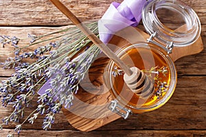 fragrant fresh lavender honey in a glass jar close-up. horizontal top view