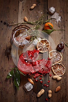 Fragrant fruit tea with tangerines, dried lemons and rosemary on a wooden table. Country style