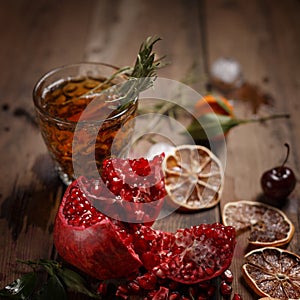 Fragrant fruit tea with tangerines, dried lemons and rosemary on a wooden table. Country style