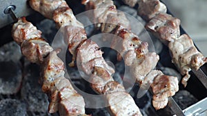 Fragrant kebab is roasted on skewers on the grill rotating