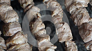 Fragrant kebab is roasted on skewers on the grill rotating