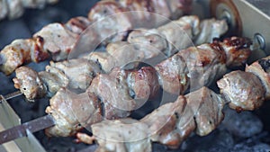 Fragrant kebab is roasted on skewers on the grill rotating