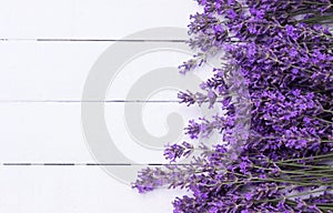 Fragrant lavender flowers on a white wooden background. Place for text