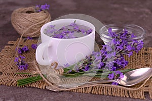 Fragrant lavender tea in a cup bouquet of fresh lavender flowers.Close-up.