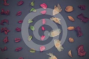 Fragrant potpourri on black background, top view. Geometric background, retro haze.