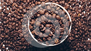 Fragrant roasted coffee beans in a plastic cup inside,top view,close-up