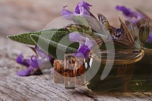 Fragrant sage oil in a glass bottle macro. horizontal