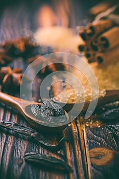 Fragrant spices for Christmas baking on wooden background