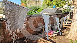 Fraid worn hessian bunting flags hanging between two trees