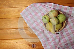 Frail of apples and pears on a towel on wooden table flat lay