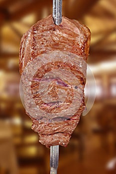 Fraldinha, bovine kind of flank steak, traditional brazilian barbecue whole piece on skewer isolated white background