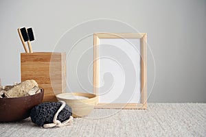 Frame, bath set, toothbrushes on cloth, gray background. Natural product, bodycare concept.