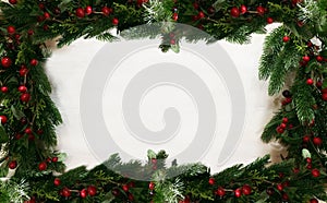 Frame border of green fir branches and red berries with empty white background as festive table ornament for Hanukkah or Christmas