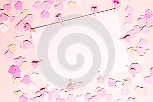 Frame, blank, paper for text, congratulation and copy space on a pastel pink background with small hearts, top view. Valentine Day