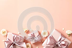 Frame border of gift boxes with pink ribbon bow, rose buds on peach fuzz background