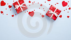 Frame border made of red gift boxes and hearts on blue background. Valentine`s Day, Love, Romantic concept. Flat lay, minimal