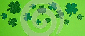 Frame border of shamrock and four leaf clovers on green background. Happy St. Patrick`s Day concept