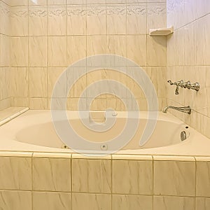 Frame Built in bathtub and shower inside a bathroom with shiny wall and small window