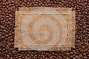 Frame of burlap and coffee beans lying on a white background
