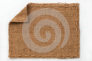 Frame of burlap with curled edges, lies on a white background