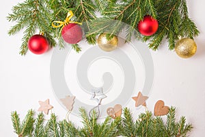 Frame from Christmas toys and natrual fir branches on a white background photo