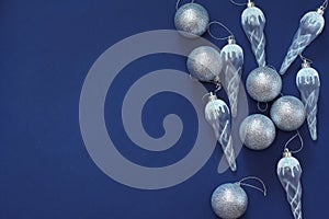 Frame of Christmas tree toys on a dark blue background. New year decorations. Top view, flat lay, copy space