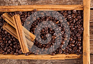 Frame with coffee beans and celyon cinnamon