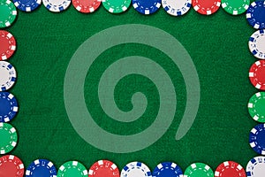 Frame of Colorful gambling chips on green background with copy space