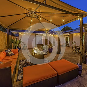 Frame Cozy outdoor seating area under a pavilion on the patio paved with stone bricks