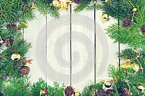 Frame from decorated Christmas tree on rustic wooden background