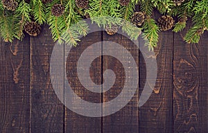 Frame from decorated Christmas tree on rustic wooden background