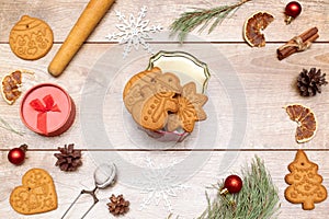 Frame of different delicious Christmas gingerbread cookies, decorations with gift box on wooden table, flat lay. Copy